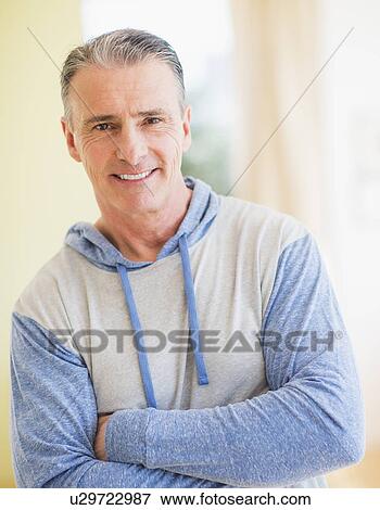 Stock Photo - Portrait of man with arms crossed. Fotosearch