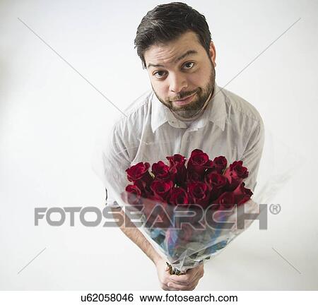 Stock Photograph - Portrait of man with bouquet. Fotosearch