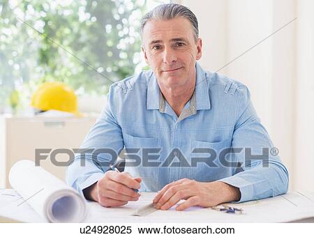 Portrait of man working in office View Large Photo Image Stock Photography - Portrait of man working in office. Fotosearch