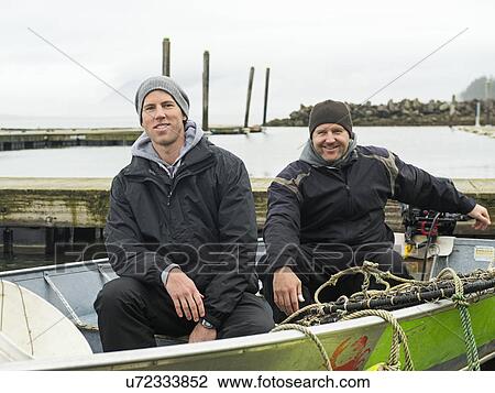 Stock Image - Portrait of men in boat. Fotosearch