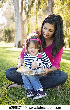 Portrait of mother and daughter (4-5) sitting in park View Large Photo Image Stock Photo - Portrait of mother and daughter (4-5) sitting in park. Fotosearch