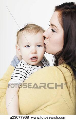 Stock Photo - Portrait of mother with daughter (12-17 months). Fotosearch