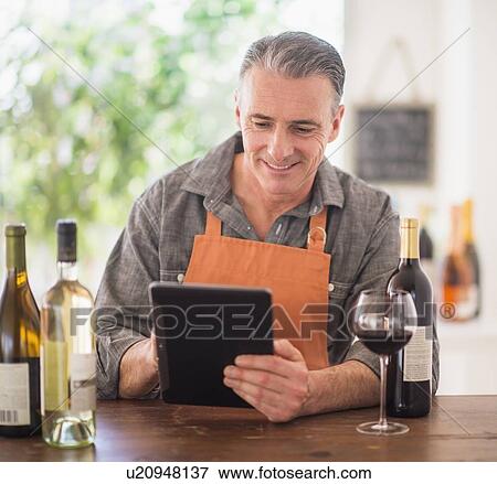 Portrait of restaurant owner using digital tablet View Large Photo Image Stock Photo - Portrait of restaurant owner using digital tablet. Fotosearch