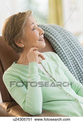 Stock Image - Portrait of senior woman at home. Fotosearch