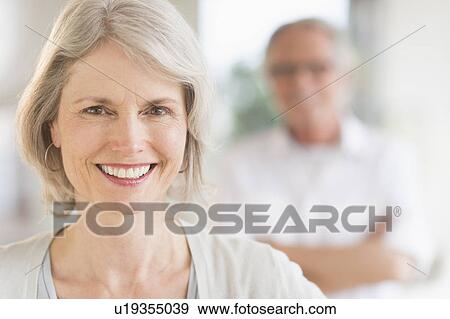 Portrait of senior woman, man in background View Large Photo Image Stock Photo - Portrait of senior woman, man in background. Fotosearch