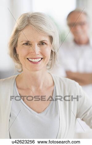 Portrait of senior woman, man in background View Large Photo Image Stock Photograph - Portrait of senior woman, man in background. Fotosearch