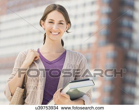 Portrait of smiling female student with book View Large Photo Image Picture - Portrait of smiling female student with book. Fotosearch