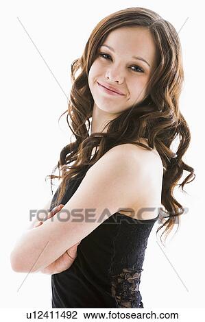 Portrait of smiling girl (12-13) with arms crossed View Large Photo Image Stock Image - Portrait of smiling girl (12-13) with arms crossed. Fotosearch