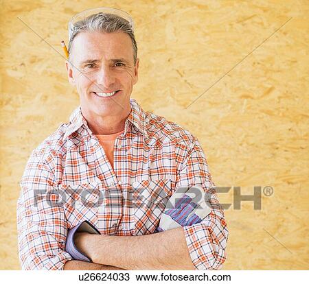 Portrait of smiling manual worker with arms crossed View Large Photo Image Stock Image - Portrait of smiling manual worker with arms crossed. Fotosearch