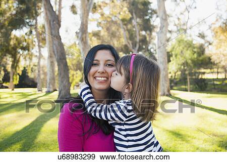 Portrait of smiling mother and daughter (4-5 years) kissing her View Large Photo Image Stock Photo - Portrait of smiling mother and daughter (4-5 years) kissing her. Fotosearch
