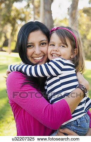 Portrait of smiling mother and daughter (4-5 years) hugging View Large Photo Image Stock Photography - Portrait of smiling mother and daughter (4-5 years) hugging. Fotosearch