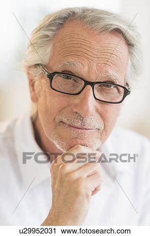 Stock Image - Portrait of smiling senior man. Fotosearch