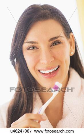Portrait of woman brushing her teeth View Large Photo Image Stock Photo - Portrait of woman brushing her teeth. Fotosearch