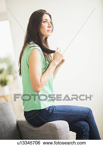 Stock Photograph - Portrait of woman daydreaming. Fotosearch