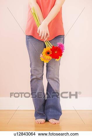 Picture - Portrait of woman holding flowers. Fotosearch