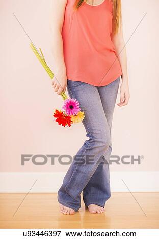 Stock Photo - Portrait of woman holding flowers. Fotosearch