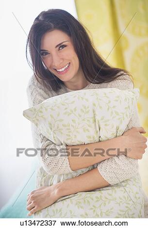 Portrait of woman holding pillow, Looking at camera View Large Photo Image Stock Photo - Portrait of woman holding pillow, Looking at camera. Fotosearch