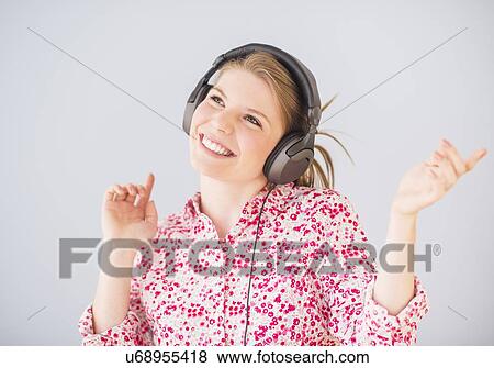 Stock Photo - Portrait of woman in headphones. Fotosearch