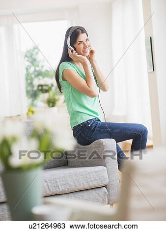 Portrait of woman listening to music on headphones View Large Photo Image Stock Image - Portrait of woman listening to music on headphones. Fotosearch