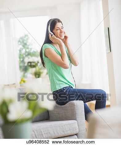 Portrait of woman listening to music on headphones View Large Photo Image Stock Image - Portrait of woman listening to music on headphones. Fotosearch