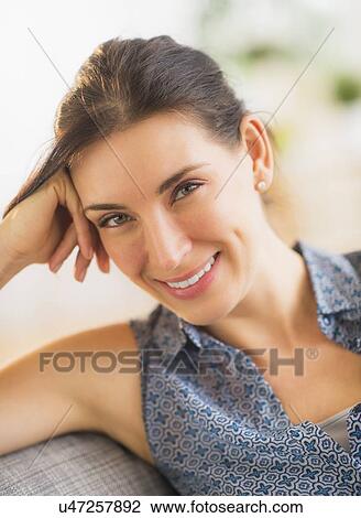 Portrait of woman relaxing on sofa View Large Photo Image Stock Image - Portrait of woman relaxing on sofa. Fotosearch