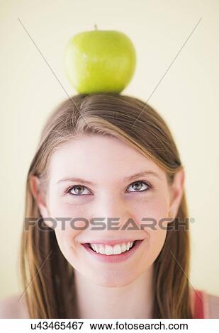Portrait of woman with apple on head View Large Photo Image Stock Photo - Portrait of woman with apple on head. Fotosearch