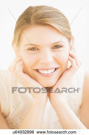 Stock Photo - Portrait of young cheerful woman. Fotosearch