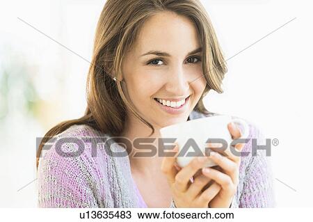 Portrait of young woman drinking tea View Large Photo Image Stock Image - Portrait of young woman drinking tea. Fotosearch