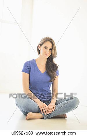 Portrait of young woman sitting on floor View Large Photo Image Stock Photo - Portrait of young woman sitting on floor. Fotosearch