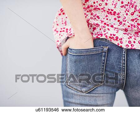 Rear view of woman with hands in pocket View Large Photo Image Stock Photograph - Rear view of woman with hands in pocket. Fotosearch