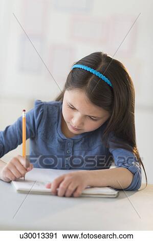 Schoolgirl (8-9) writing in notebook View Large Photo Image Stock Image - Schoolgirl (8-9) writing in notebook. Fotosearch