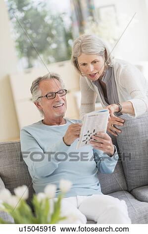 Stock Photograph - Senior couple doing crossword. Fotosearch