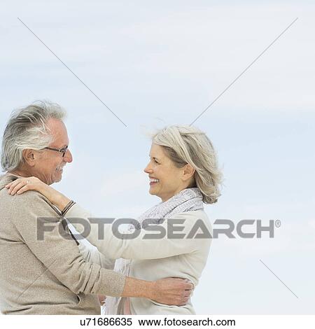 Stock Photography - Senior couple embracing outdoors. Fotosearch