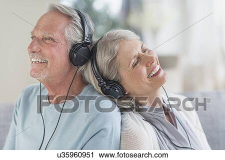Stock Image - Senior couple listening to music at home. Fotosearch