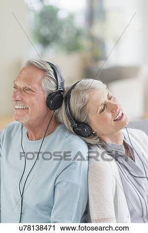 Senior couple listening to music at home View Large Photo Image Stock Image - Senior couple listening to music at home. Fotosearch