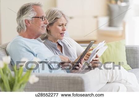 Senior couple paying bills via internet View Large Photo Image Stock Photo - Senior couple paying bills via internet. Fotosearch
