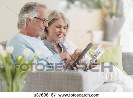Senior couple paying bills via internet View Large Photo Image Stock Photo - Senior couple paying bills via internet. Fotosearch