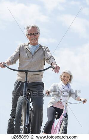 Senior couple riding bicycle View Large Photo Image Stock Image - Senior couple riding bicycle. Fotosearch