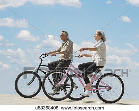 Stock Photo - Senior couple riding bicycle. Fotosearch