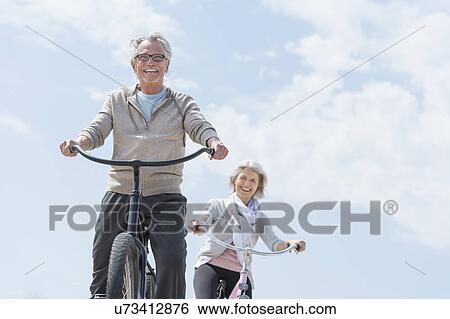 Senior couple riding bicycle View Large Photo Image Stock Photograph - Senior couple riding bicycle. Fotosearch