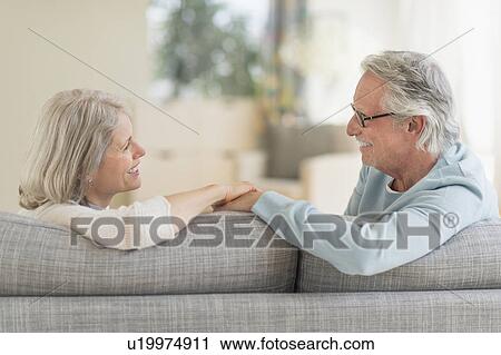 Senior couple sitting on sofa View Large Photo Image Stock Image - Senior couple sitting on sofa. Fotosearch