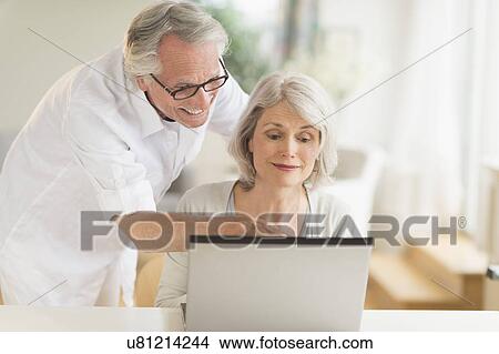 Picture - Senior couple using laptop. Fotosearch