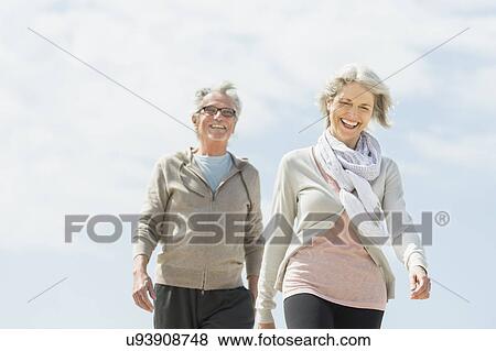 Senior couple walking View Large Photo Image Stock Photo - Senior couple walking. Fotosearch