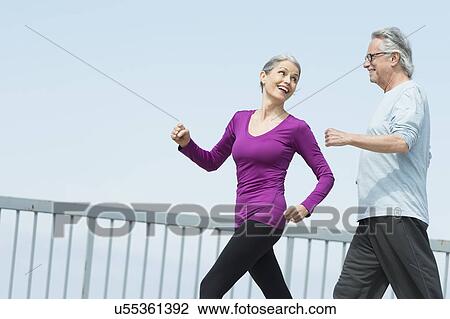 Stock Image - Senior couple walking together. Fotosearch