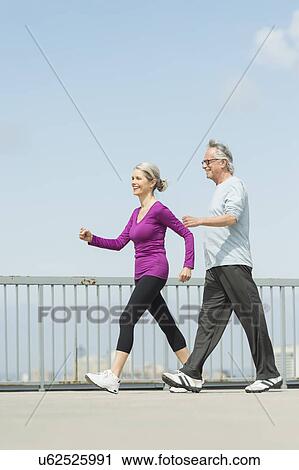 Stock Image - Senior couple walking together. Fotosearch