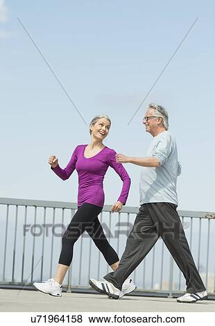 Stock Photo - Senior couple walking together. Fotosearch