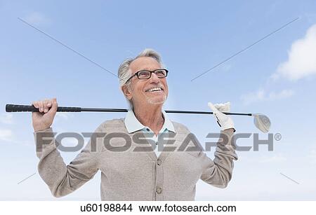 Senior man holding golf club View Large Photo Image Picture - Senior man holding golf club. Fotosearch