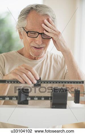 Senior man on weight scale View Large Photo Image Stock Image - Senior man on weight scale. Fotosearch