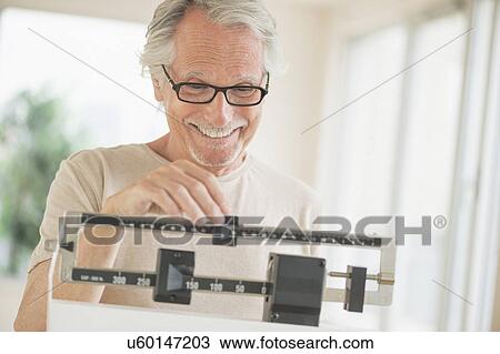 Senior man on weight scale View Large Photo Image Stock Image - Senior man on weight scale. Fotosearch