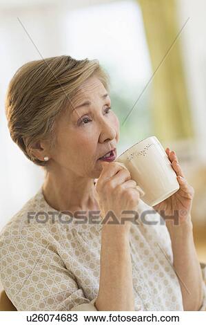 Senior woman drinking from mug View Large Photo Image Stock Image - Senior woman drinking from mug. Fotosearch
